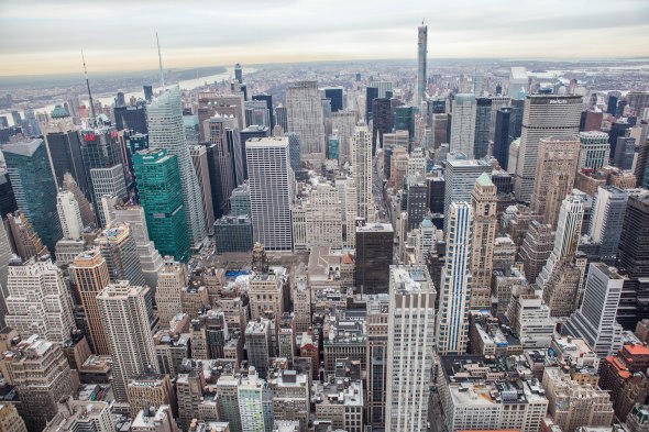 Aerial perspective photo of a lot of tall buildings in midtown Manhattan, facing north to Central Park.
